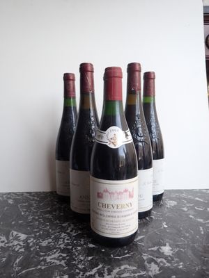 several bottles of wine are lined up on a table