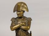 bronze statue of a man in a military uniform with a sword