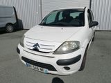 a small white car parked in front of a building