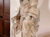 a statue of a woman holding a child on a pedestal