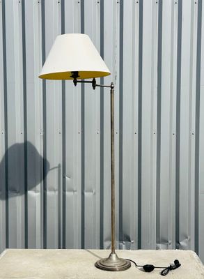 a table with a lamp on it next to a metal wall