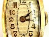 a close up of a watch on a white surface