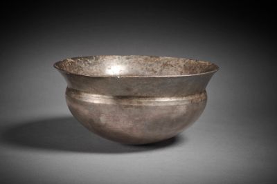 a silverware bowl with two handles on a gray surface