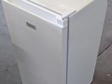 an image of a white refrigerator in a warehouse