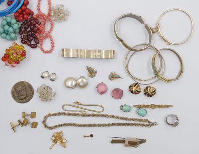 many different types of jewelry on a white surface
