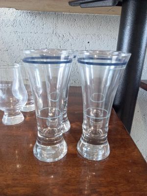 four glasses sitting on a table next to each other