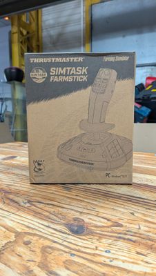 une boîte en carton posée sur une table en bois, avec une télécommande
