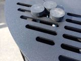 a close up of a black trash can with some coins on it