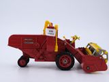 a toy tractor with a loader attached to the back of it