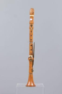 a wooden instrument that is on display on a stand
