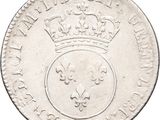a close up of a silver coin with a crown on it