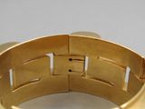 gros plan d'un bracelet en or sur une table