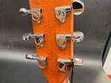a guitar that is sitting on a stand in front of a sign