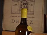 a bottle of wine sitting on a table next to a box