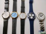 several different types of watches are lined up on a table