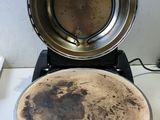 a dirty pan sitting on top of a stove next to a frying pan