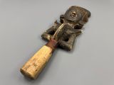 a close up of a wooden object with a baseball bat on a table