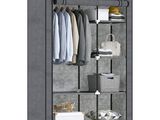 an image of a closet with clothes hanging on it