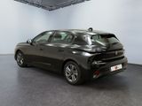 the rear end of a black car in a large room