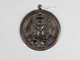 an image of a bronze medal with a woman ' s face on it