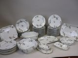 a lot of plates and bowls sitting on a table