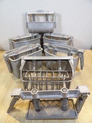 a metal shopping cart that is sitting on a wooden table