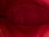 the inside of a red handbag with a zipper on it