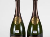 two bottles of krug champagne on a white background