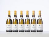 six bottles of white wine lined up in a row