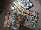 a lot of coloring books on the floor next to each other