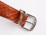 a close up of a brown leather belt with a silver buckle
