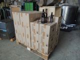 several boxes of beer are stacked on a pallet in a garage