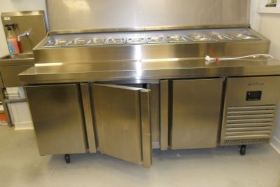 a large stainless steel kitchen with a refrigerator and freezer