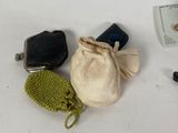a small bag with a cell phone and other items on a table