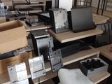 a lot of computer equipment that are on the floor