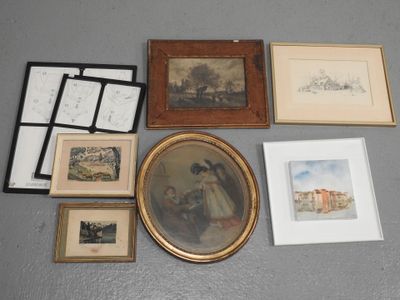 many framed and unframed pictures on the floor