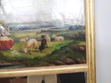 a man standing in front of a painting of a woman and sheep