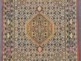 an antique persian rug with a geometric design and fringe fringes