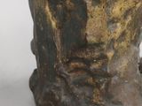 a statue of a man ' s head on a white surface