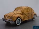 a car covered with a tarp sitting on the floor