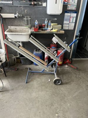 a toilet and a sink in a room with a lot of tools