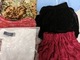 a pile of clothes and a purse on a table