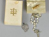 rosary, box, and rosary chain with a cross on it