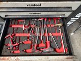 someone standing in front of a tool drawer with tools in it