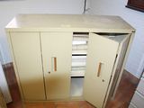 a small cabinet with two doors open in a room