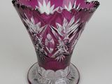 a purple glass vase that is sitting on a table