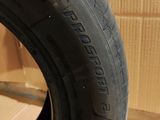 the tire of a car is sitting on the floor in front of a cardboard box