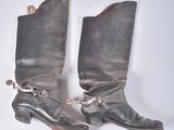 two pairs of boots that are sitting on a table