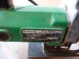 a green machine that is sitting on a table