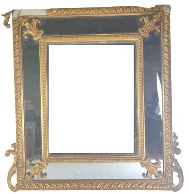 a mirror with a gold frame on a white wall